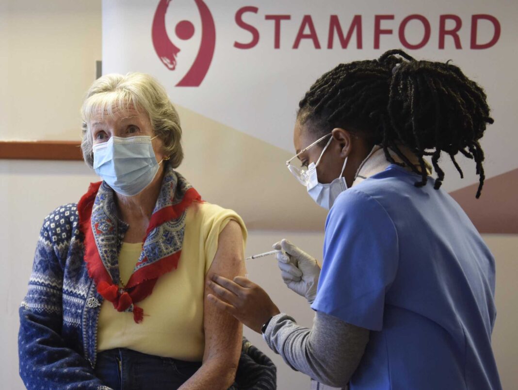 Greenwich's Marjory Tait receives the COVID-19 vaccine from Krystina Byas, LPN, at the COVID-19 vaccination clinic at Stamford Hospital in Stamford, Conn. Thursday, Jan. 21, 2021. Stamford Hospital has been administering about 1,000 coronavirus vaccines every day to groups 1-A and 1-B.